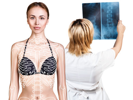 Radiologist woman checking x-ray near patient.