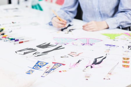 Young designer draws sketches of clothes.の写真素材