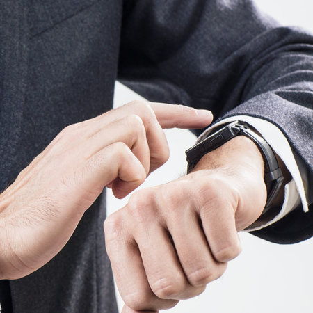 Closeup hands of man using his smartwatch.