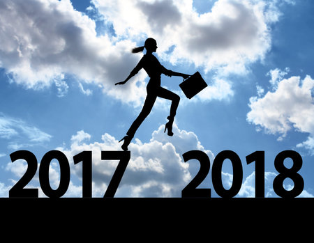Men jump over silhouette Happy New Year 2018