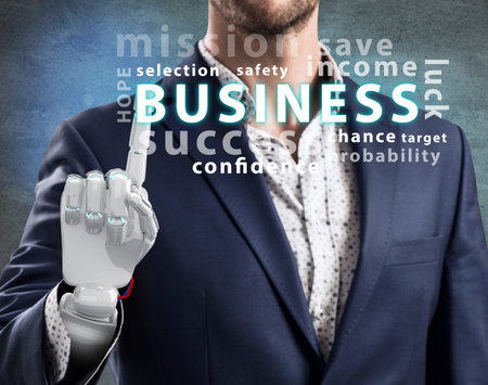 Businessman with robotic hand point on business word cloud. 3d renderingの写真素材