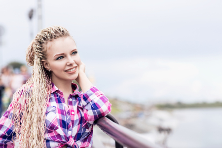 Young happy woman posing outdoors.の写真素材