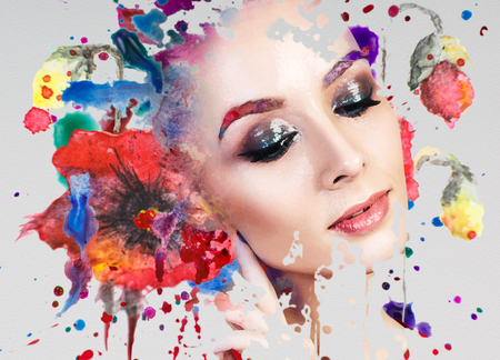 Portrait of young woman and colorful paint blots.の写真素材