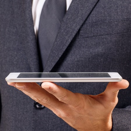 Businessman holds digital tablet. Close-up shot.の写真素材
