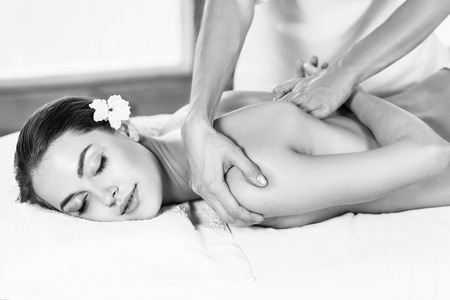 Beautiful woman lying on massage table and enjoying massage.の写真素材