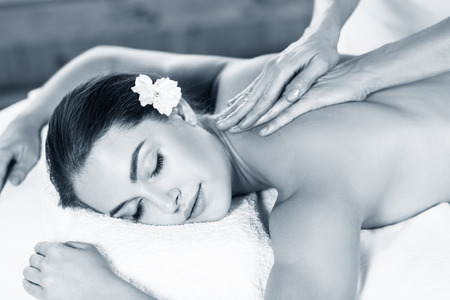 Beautiful woman lying on massage table and enjoying massage.の写真素材
