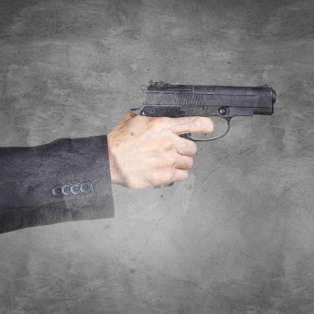 Hand holding a gun.