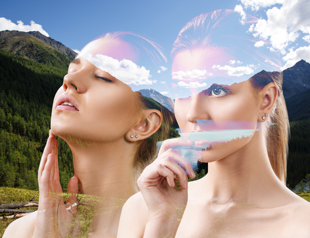 Double exposure of young woman and nature landscape.の写真素材