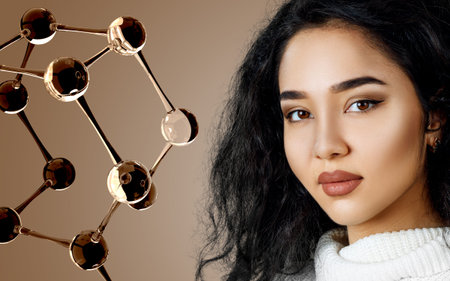 Beautiful exotic woman near big glass molecule structure.