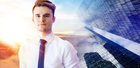 Young businessman over cityscape background.の写真素材