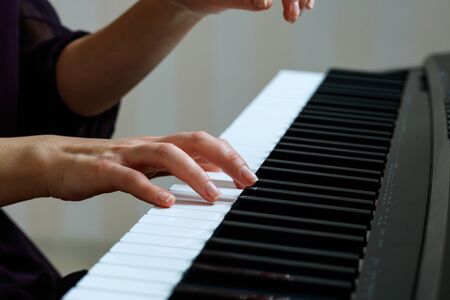 Young woman playing pianoの写真素材