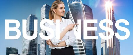 Young business woman among big letters of tag word BUSINESSの写真素材