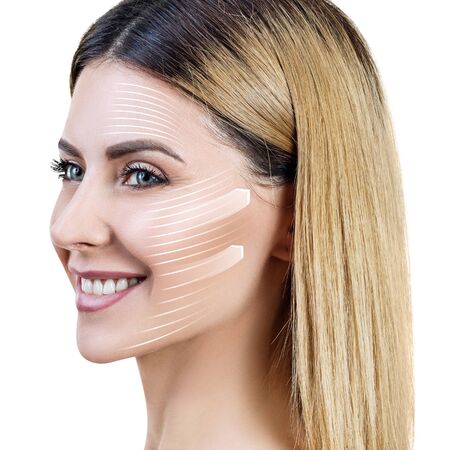 Graphic lines shows facial lifting effect on skin of beautiful woman.の写真素材