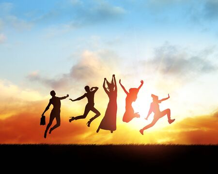 Black silhouettes of women friends jumping in sunset.の写真素材