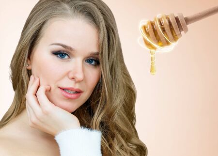 Adult woman and honey spoon prepare for facial mask.の写真素材