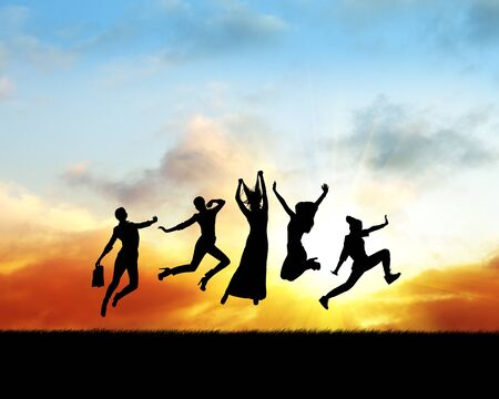 Silhouette of women jumping in sunset.の写真素材