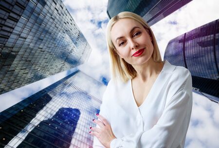 Business woman stands over cityscape background.の写真素材