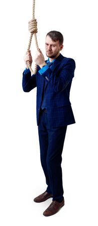 Depressed businessman wearing rope loop committing suicide.の写真素材
