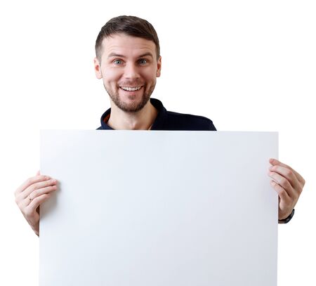 Smiling businessman holds a blank white sheet for text space.の写真素材