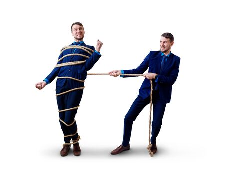 Angry businessman pulls tied himself with a rope.の写真素材