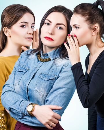 Young girls gossiping some secret.の写真素材