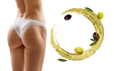 Female buttocks near swirl olive oil. Slimming and dieting concept.の写真素材