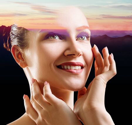 Double exposure of beautiful woman face and sunset sky.の写真素材