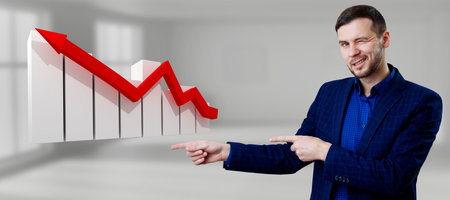 Businessman pointing on virtual graph icon with red arrow down.の写真素材
