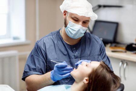 Dentist check-up teeth to young woman patient.の写真素材