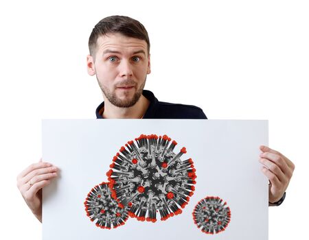 Surprised man holds white placard with coronavirus cell.の写真素材
