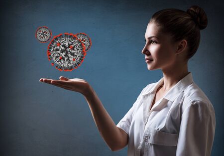 Female doctor presents viral cell coronavirus.の写真素材