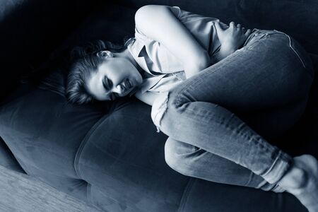 Beautiful young woman feels menstruation pain and anger.の写真素材