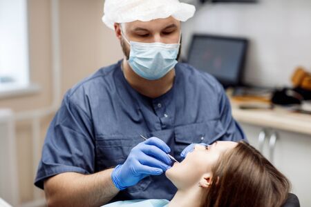 Dentist check-up teeth to young woman patient.の写真素材