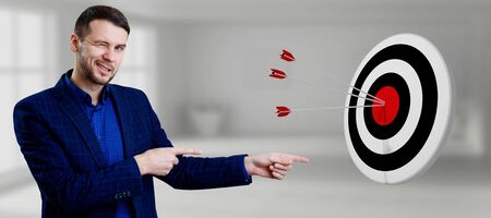 Businessman ponting hands on archery target with arrows.の写真素材