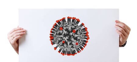 Hands holds white placard with illustration of coronavirus cell.の写真素材