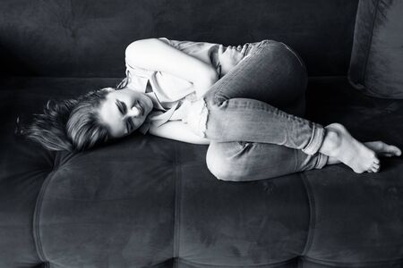 Beautiful young woman feels menstruation pain and anger.の写真素材