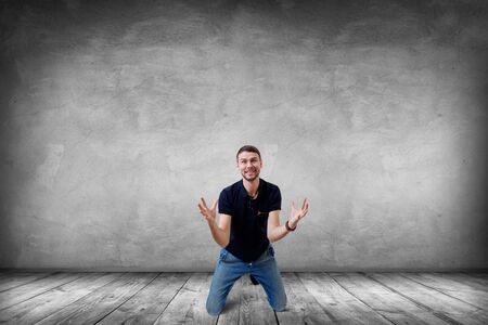 Young businessman feels triumph with crazy face.の写真素材