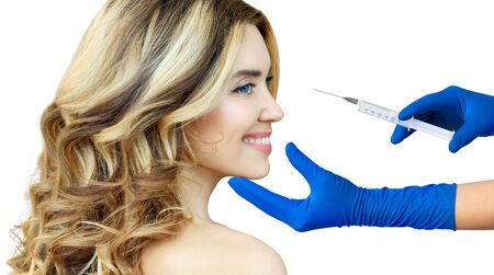 Beautiful woman gets an injection from surgeon.の写真素材