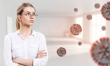 Young businesswoman among coronavirus cells.の写真素材