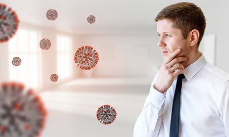 Young businessman among coronavirus cells.の写真素材
