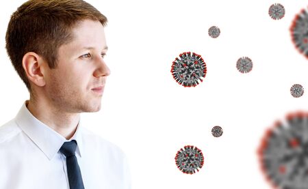 Young businessman among coronavirus cells.の写真素材