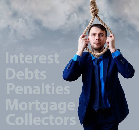 Depressed businessman wearing rope loop near tag words.の写真素材