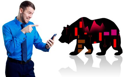 Irritated businessman holding smartphone near silhouette of bear.の写真素材
