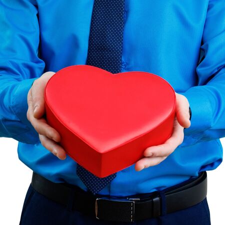 Man holds valentines gift box in the shape of heart.の写真素材