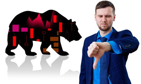 Businessman shows thumbs down gesture over bear silhouette.の写真素材