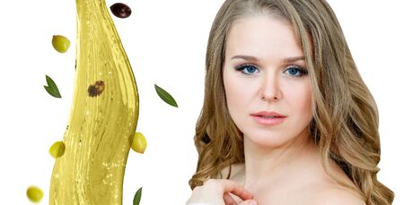 Beautiful woman near splash of olive oil. Skincare concept.の写真素材