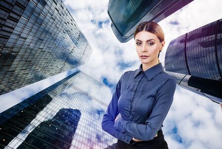 Business woman stands over cityscape background.の写真素材