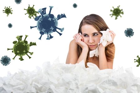 Young sad woman with a lot of hankys among coronavirus cells.の写真素材