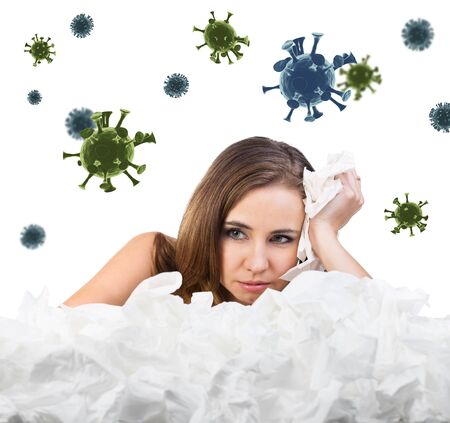 Young sad woman with a lot of hankys among coronavirus cells.の写真素材