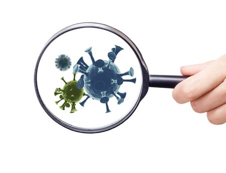 Magnifying glass shows coronovirus cells.の写真素材